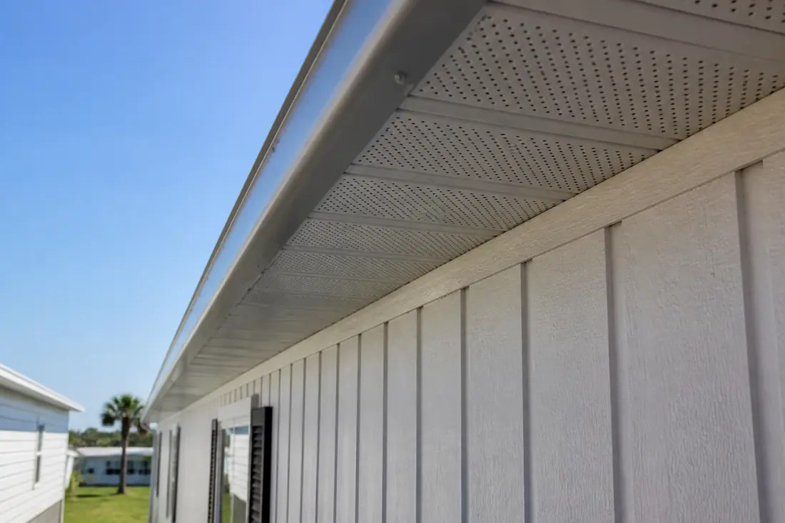 A continuous soffit vent running along the eave of a manufactured home