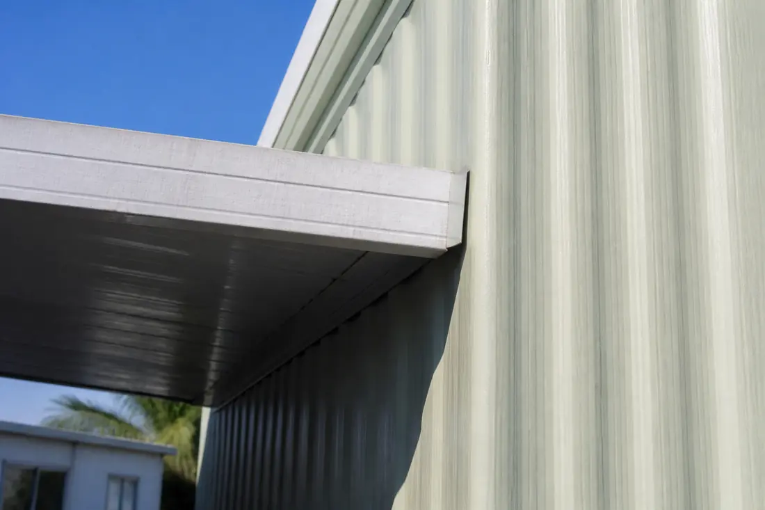 The junction where a carport roof edge meets the sidewall of a manufactured home